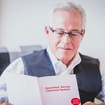 A man reads through the SmartVest brochure