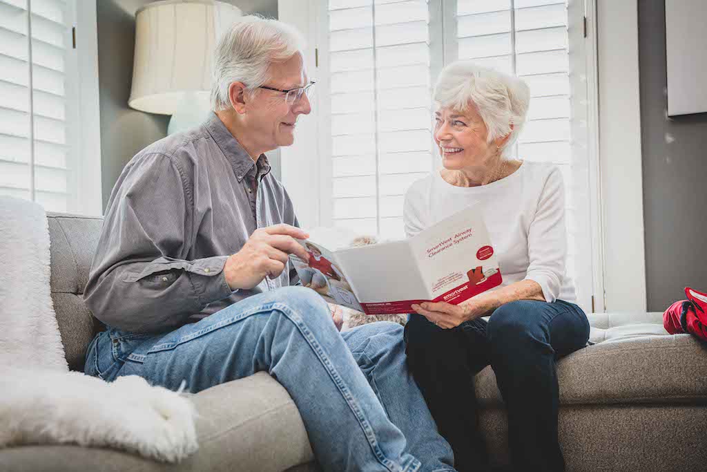 Older man and woman reviewing SmartVest patient packet
