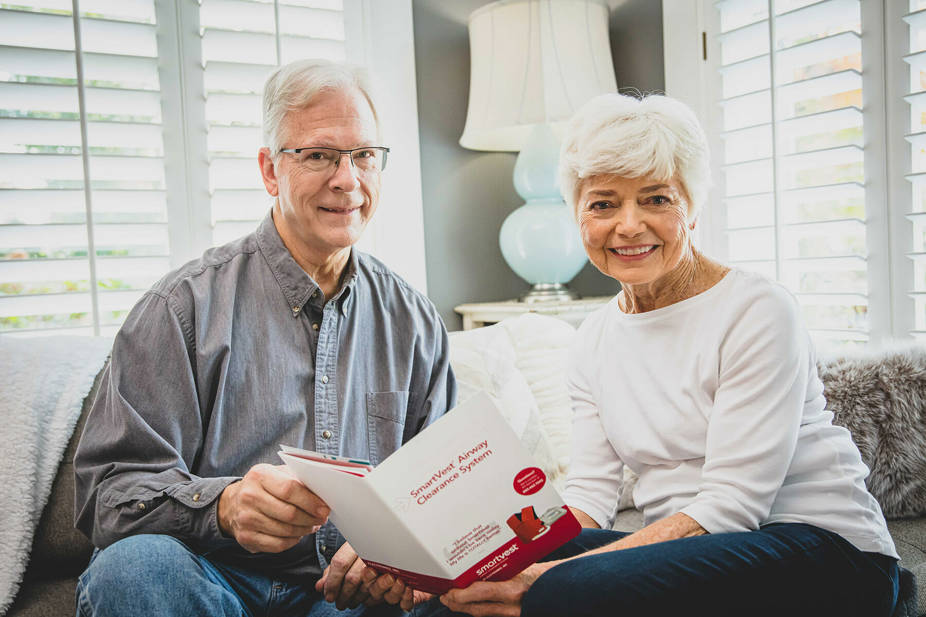 Elderly couple reading SmartVest brochure.