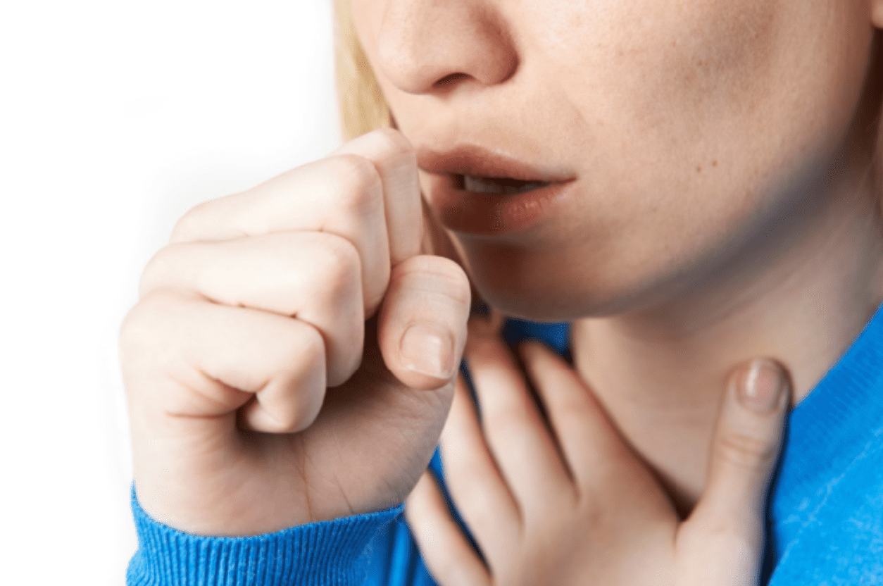 Woman coughing into hand
