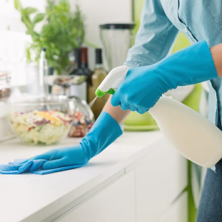 A person cleans their counters