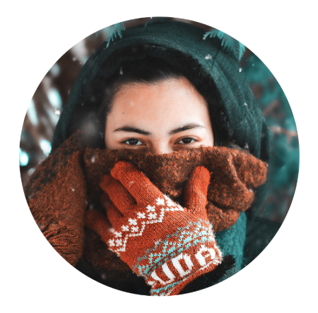 A woman covering her face with a scarf in winter