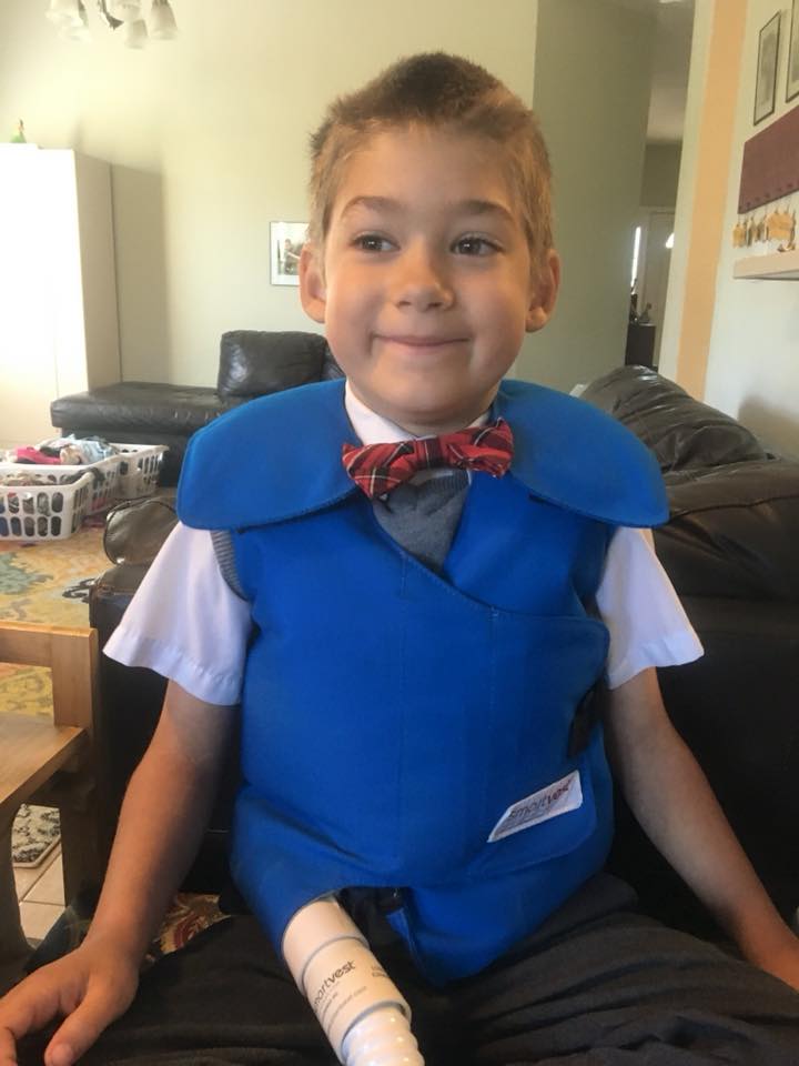 A kid wearing his SmartVest over a dress shirt