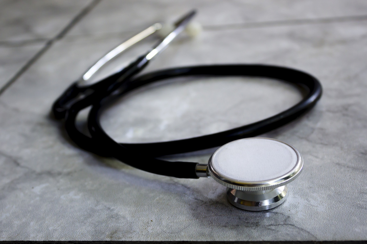 A stethoscope sitting on a stone counter