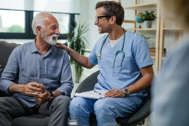 Doctor sitting with man living with chronic lung disease.