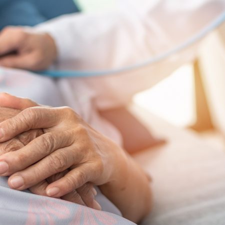 A patient holds their hands crossed on their stomach