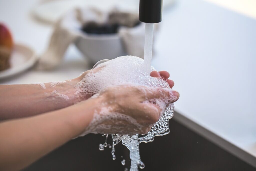 Person with COPD washing hands to avoid flu