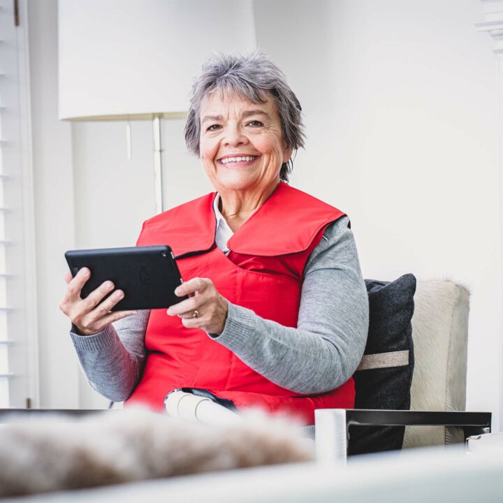 Woman using her tablet during SmartVest therapy