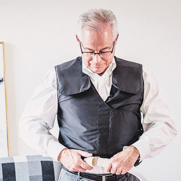 Mature man connecting his SmartVest to the generator