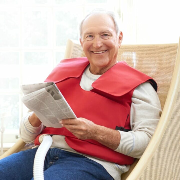 A man wears his SmartVest while reading a newspaper