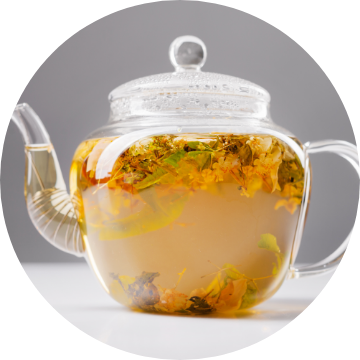 A freshly brewed pot of hot tea and lemon.