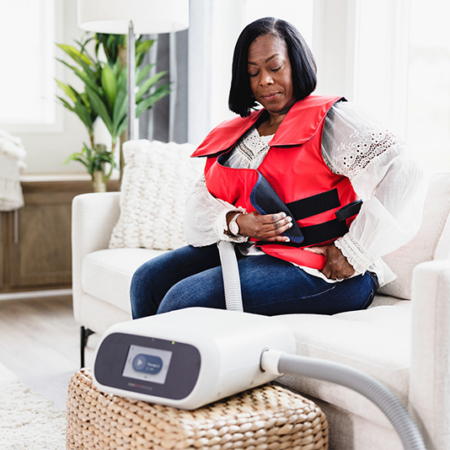 SmartVest user performing HFCWO therapy at home.