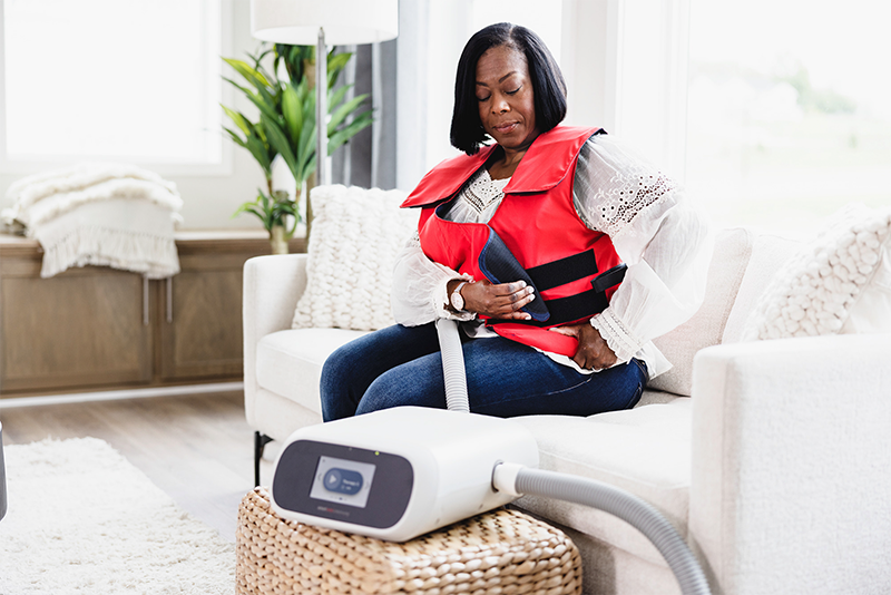 SmartVest user performing HFCWO therapy at home.