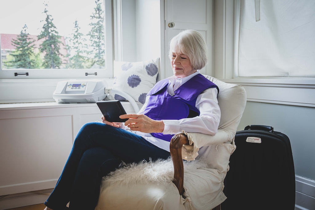 SmartVest user wearing device while reading tablet. 