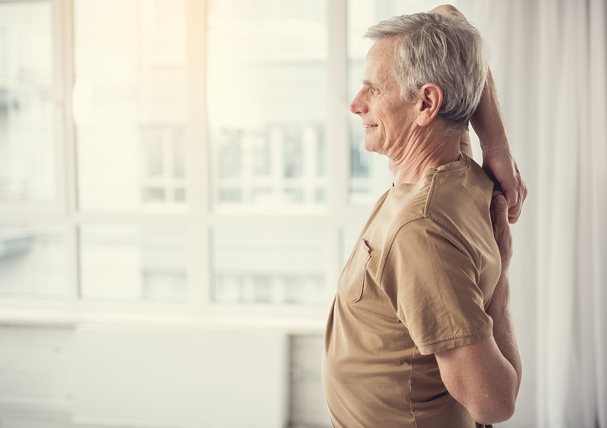 Man stretching his arms and back.